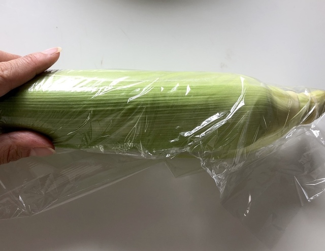 皮付きのとうもろこしをラップで包む