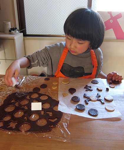 クッキー生地を型抜きする子ども