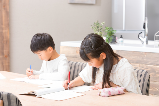 ダイニングテーブルで勉強する兄弟